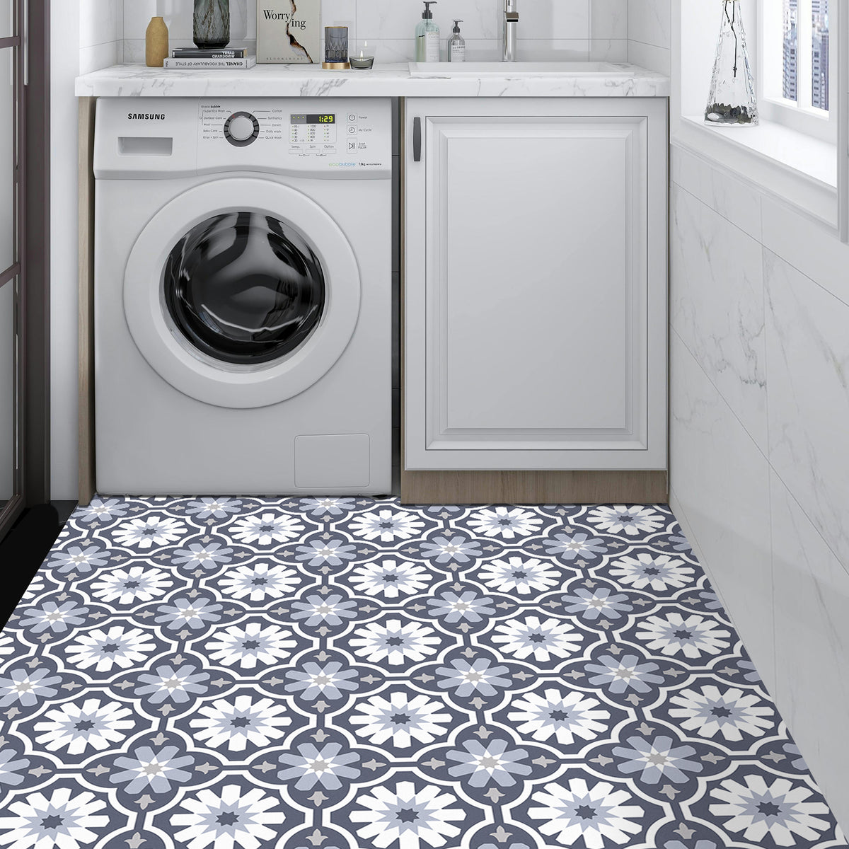 Patterned vinyl floor covering in a laundry room with washing machine and cabinets.
