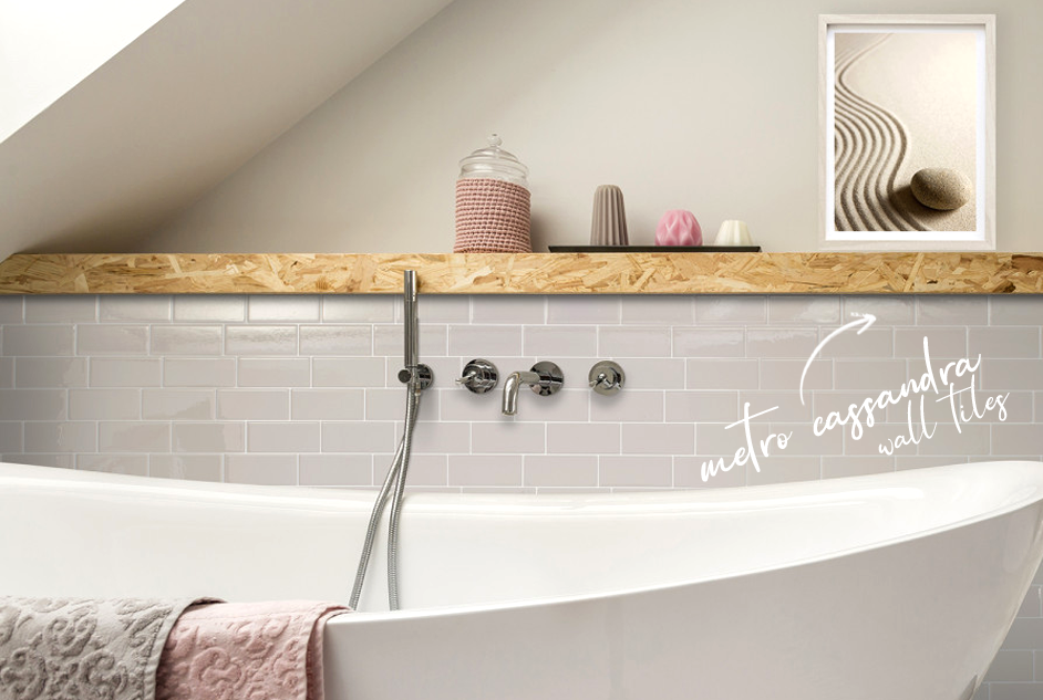 white oval free standing bath in front of wall with Metro Cassandra grey subway tiles