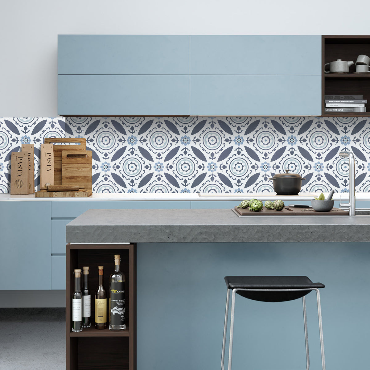 Modern kitchen with blue cabinets, concrete countertop, and decorative blue tile backsplash.