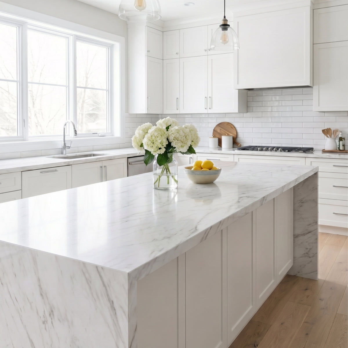 Modern kitchen with marble island and white cabinets