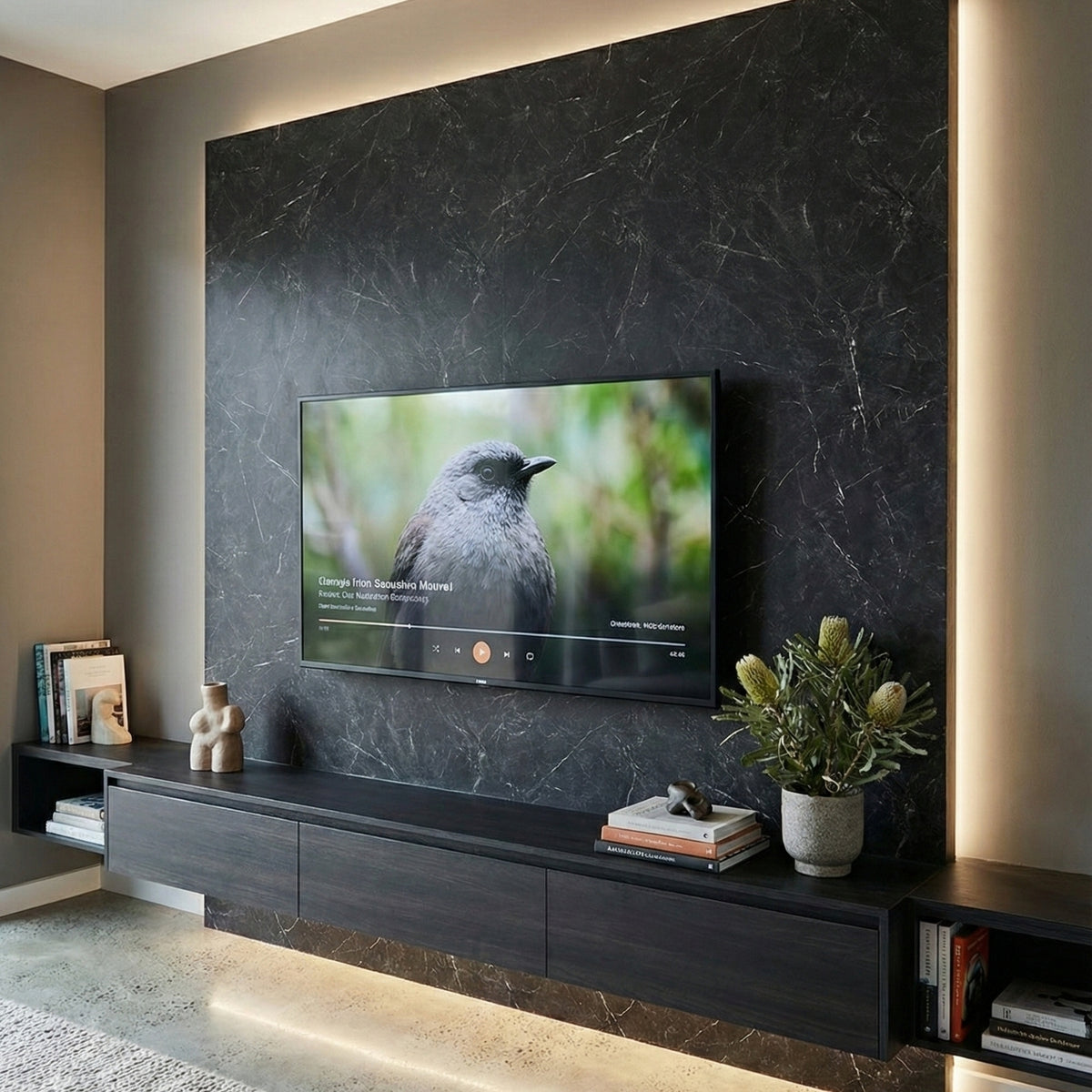 Modern living room with a large TV displaying a nature scene, placed on a dark marble architectural grade vinyl wrapped wall.