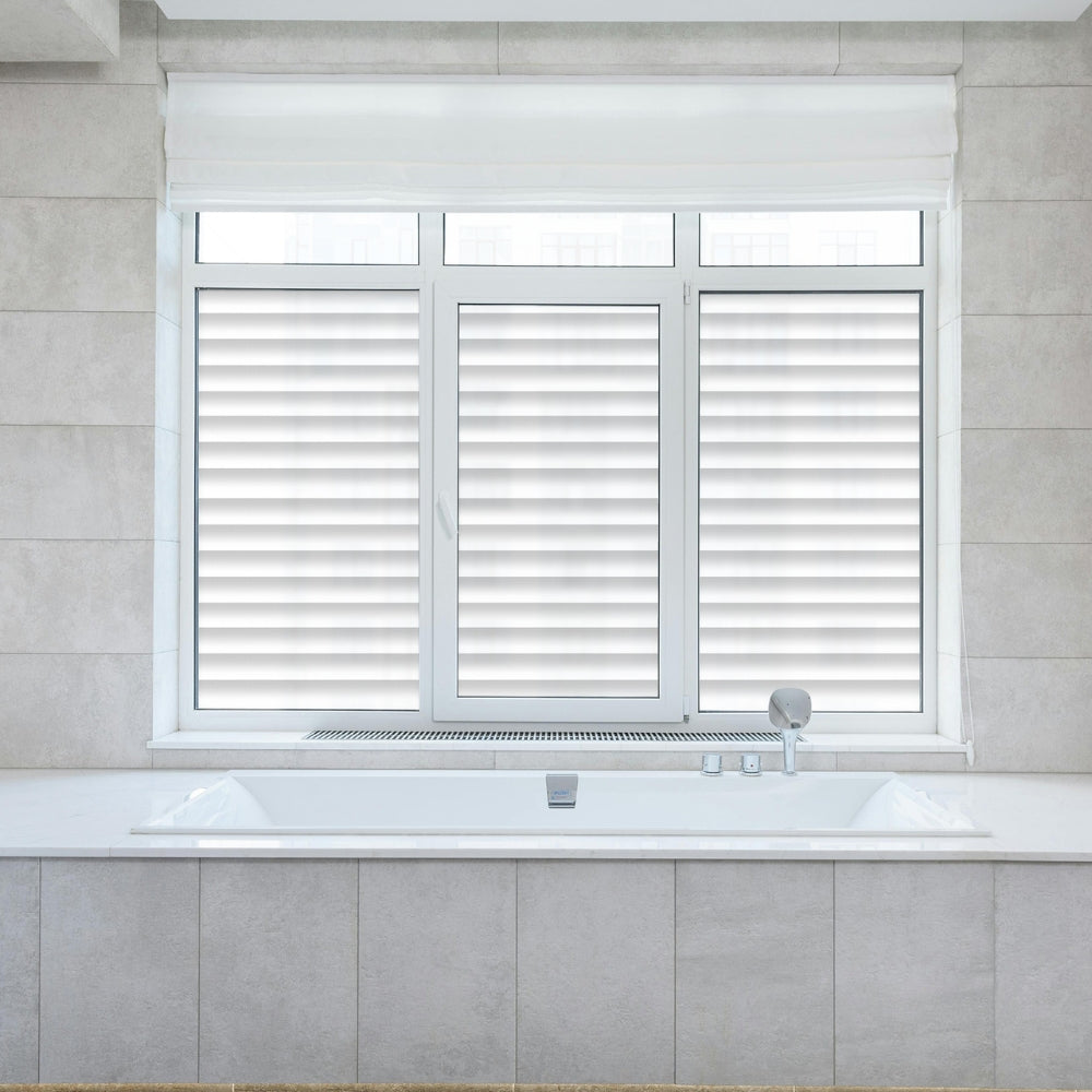 Window with white venetian blinds window film in a bathroom setting