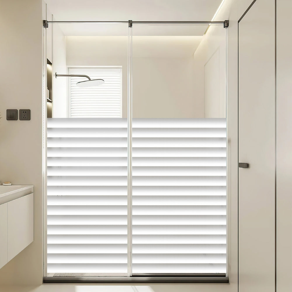 Bathroom with a glass shower enclosure featuring horizontal blinds.