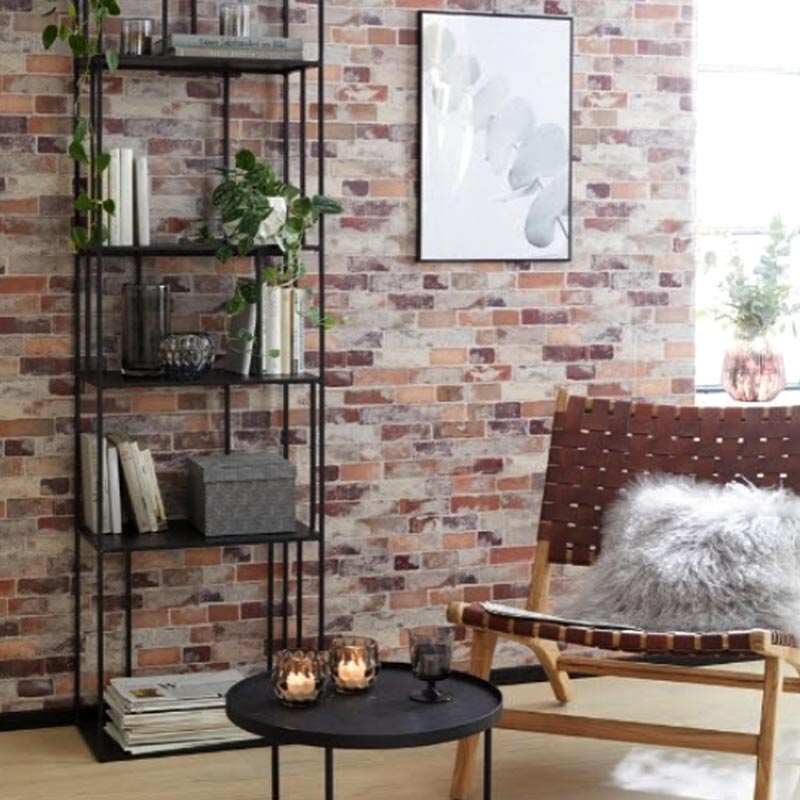 red brick wallpaper with black shelf in front, chair and black small coffee table