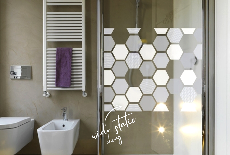 Grey hexagon window film on shower screen with text saying wido static cling