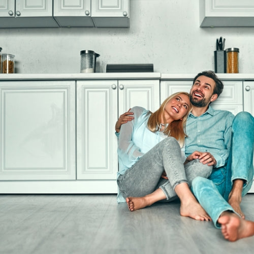 couple sitting on the floor in their rental