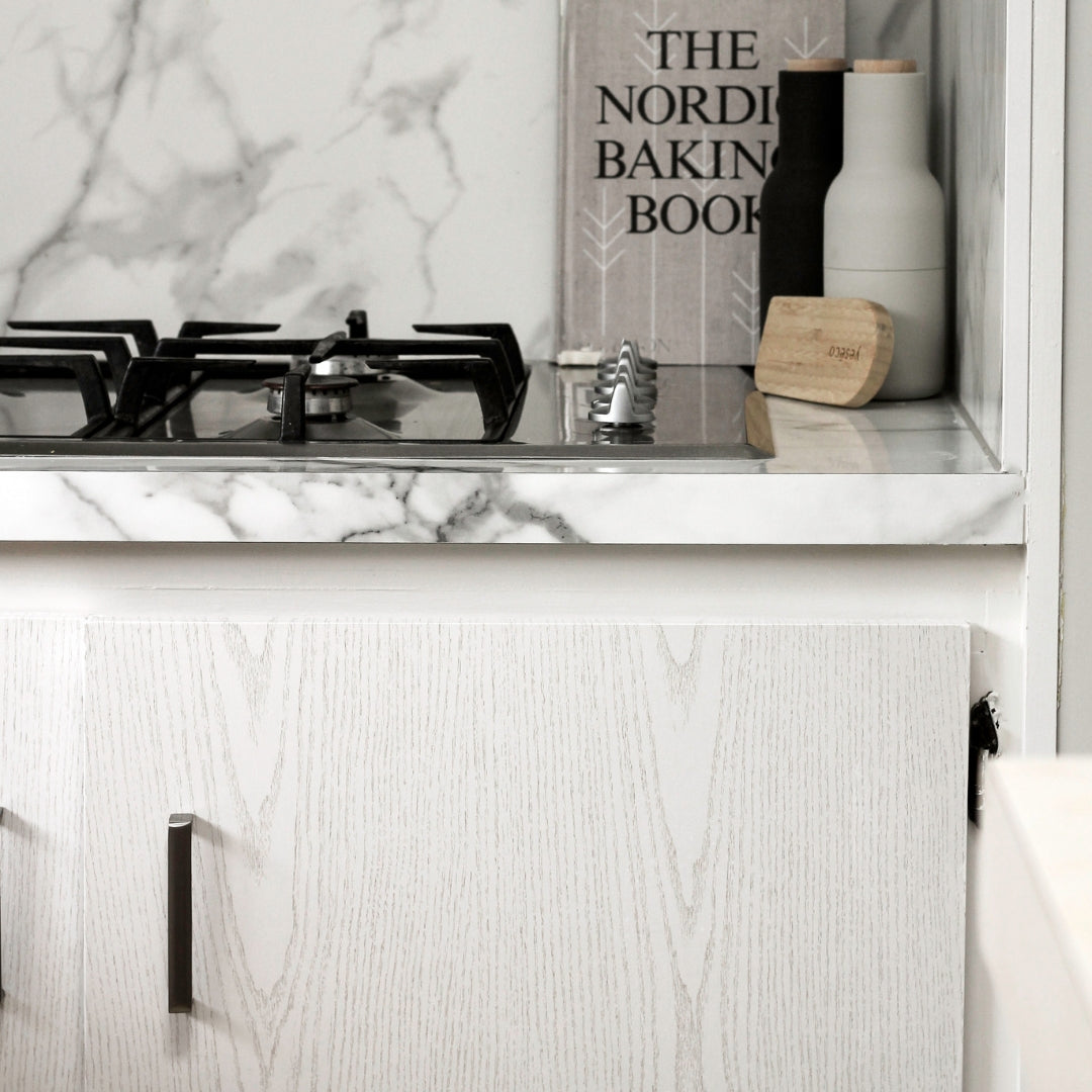 Pearlwood white vinyl wrapped kitchen cupboard, marble grey benchtop and splash back