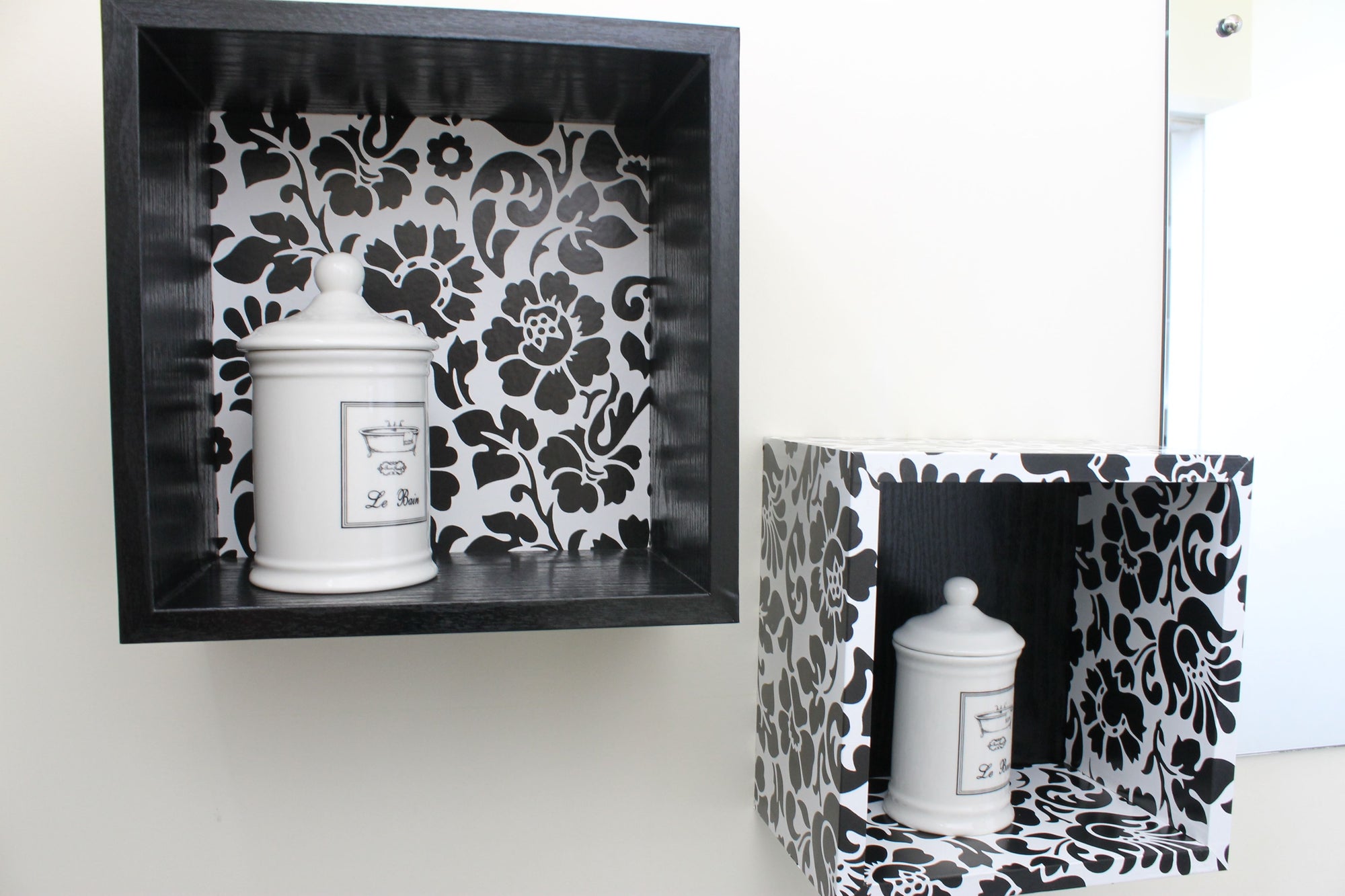 2 black and white vinyl covered box shelves