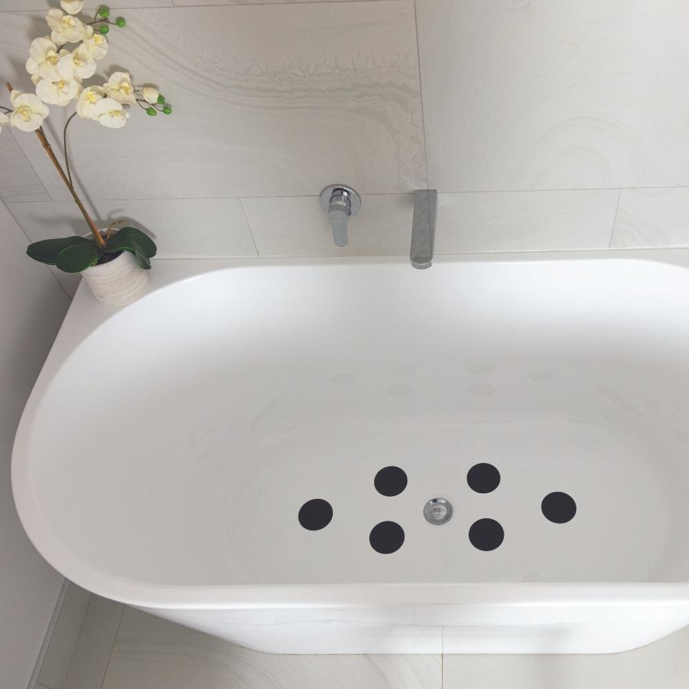 Black anti-slip grip dots to prevent slipping in a bath