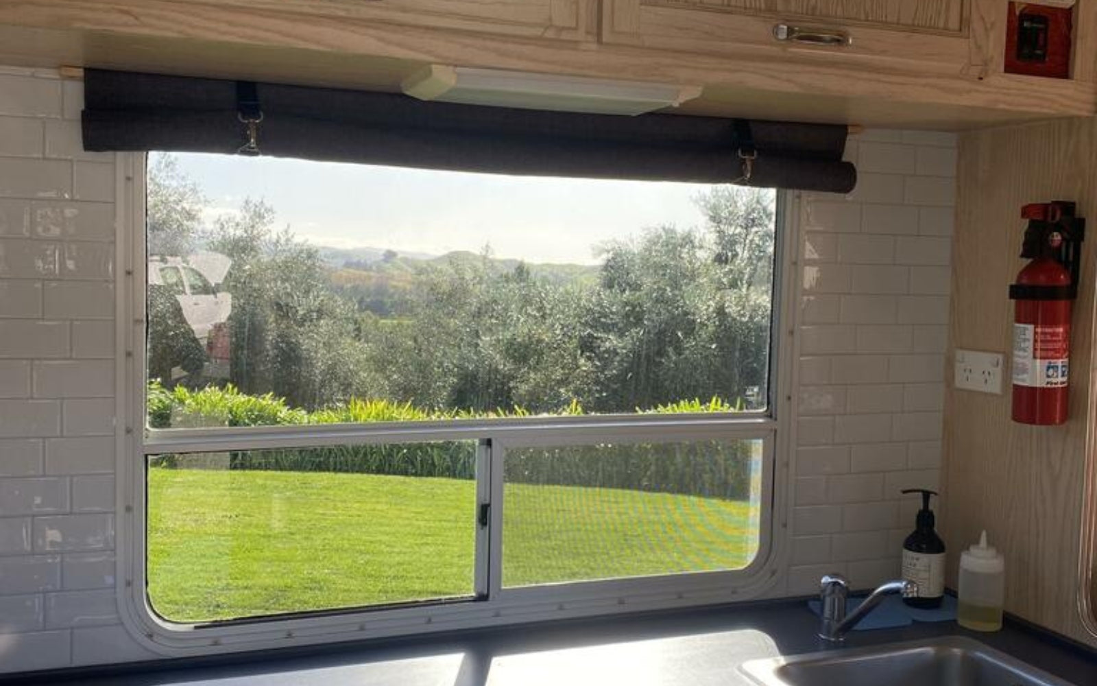white peel and stick tiles as a splashback in a caravan