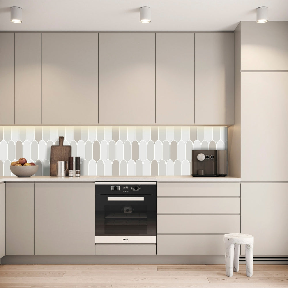 Modern kitchen with beige cabinets, grey feather tiles backsplash, and a white stool.