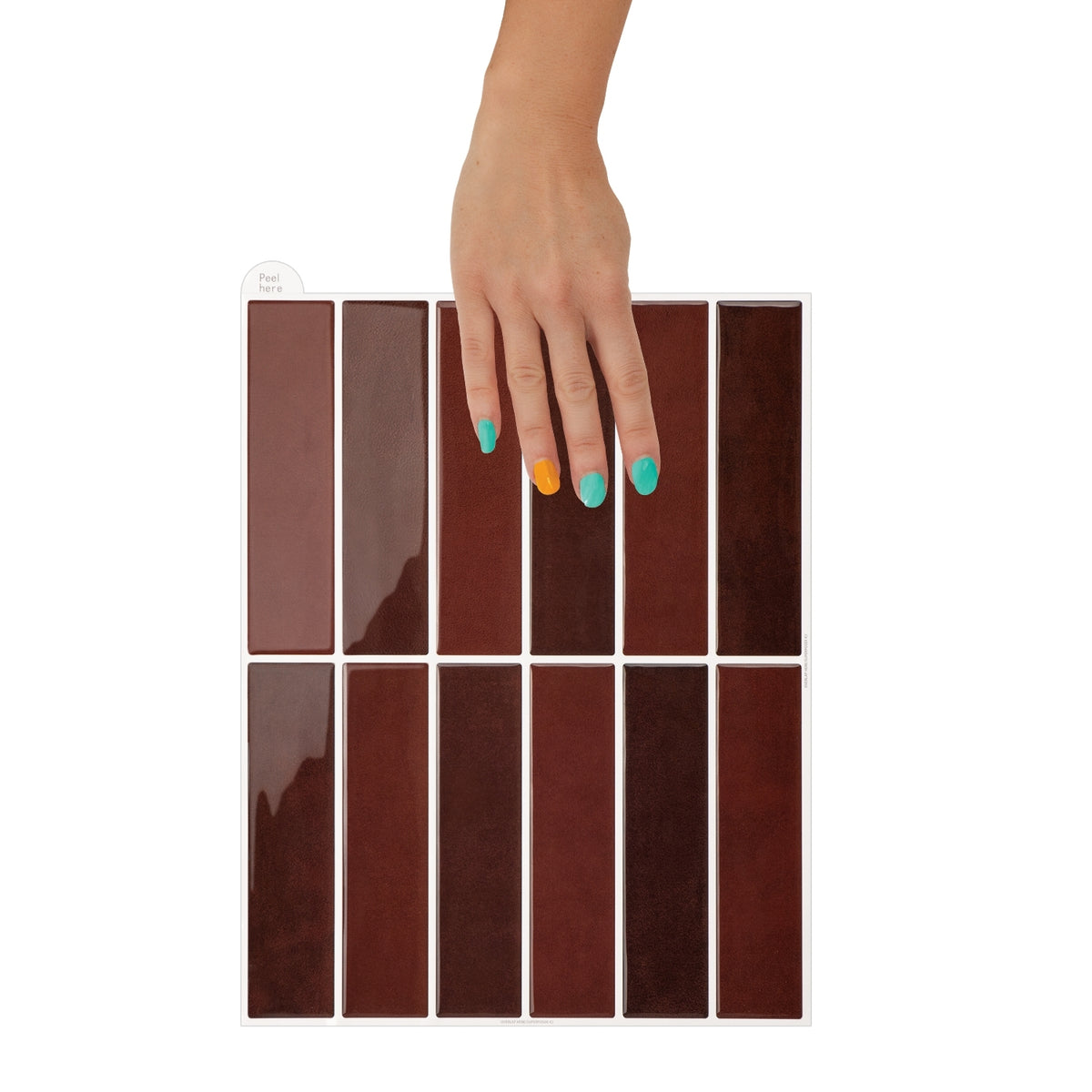 Hand with multicolored nails holding a burgundy coloured kit kat tile.