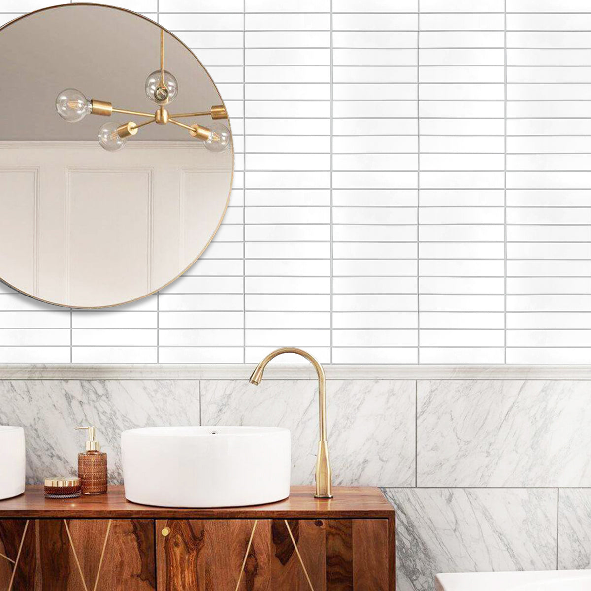 Modern bathroom with a round mirror, gold faucet, and wooden vanity.