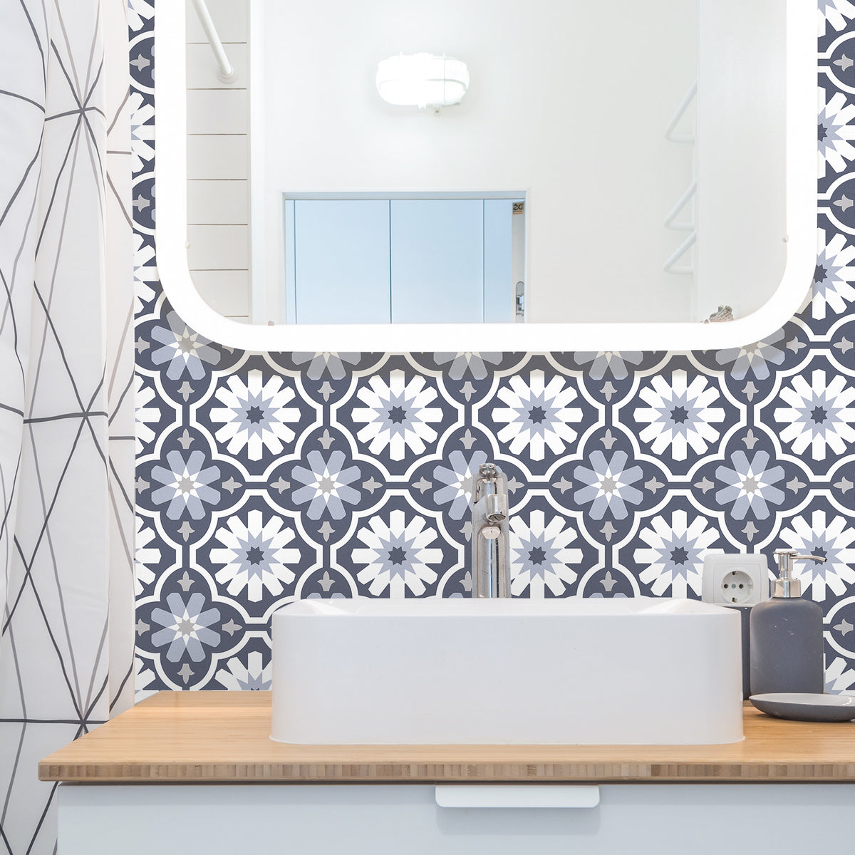 Bathroom with patterned wall tiles, sink, and mirror.