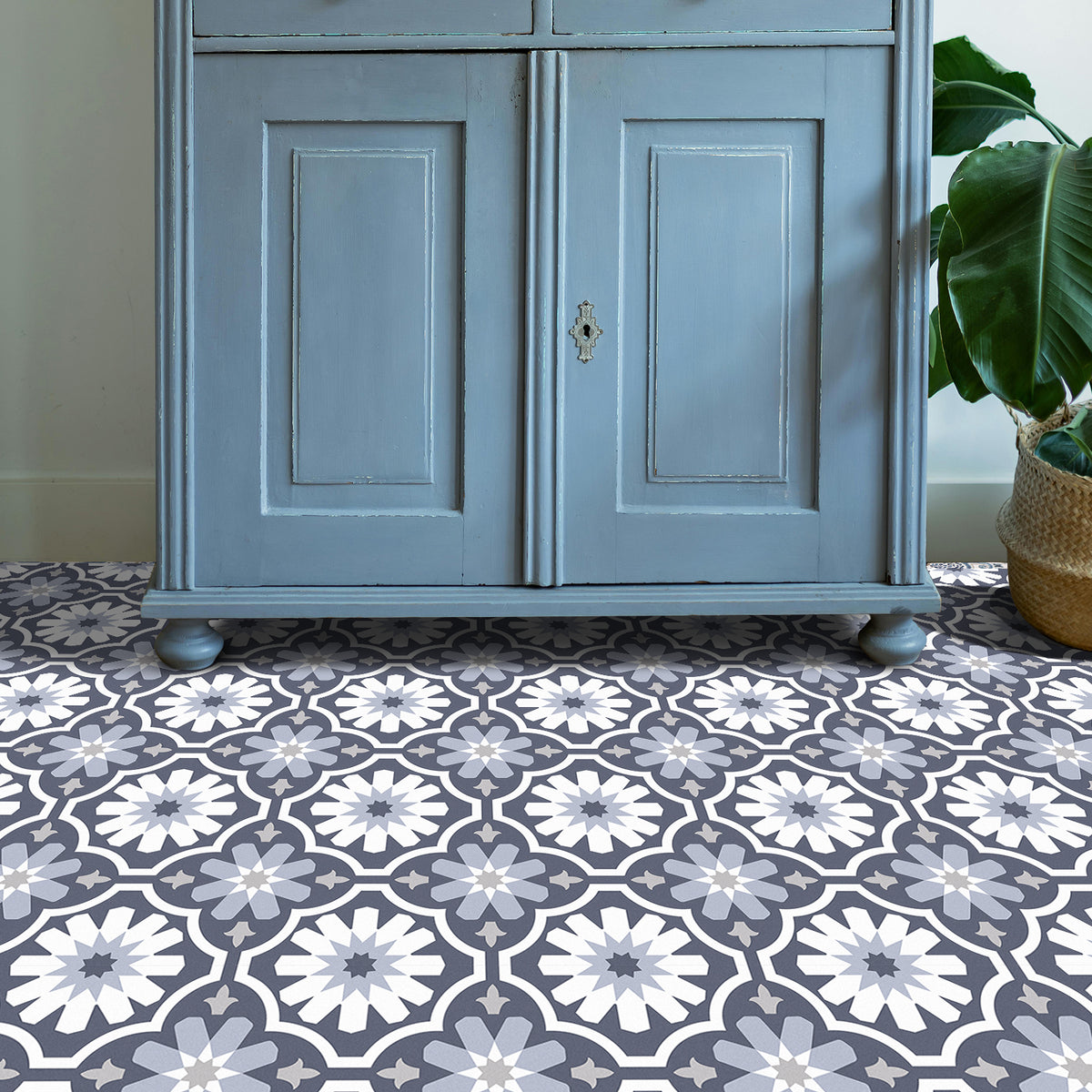 Blue cabinet with patterned floor and plant