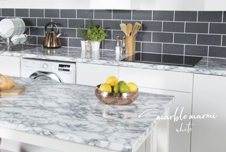 Kitchen with island and bench top wrapped in marble marmi white vinyl. White cupboards and grey subway wall tiles