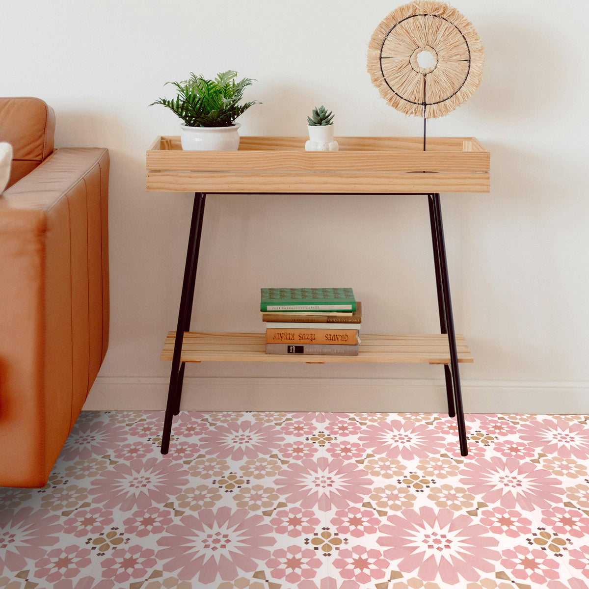 Modern console table with decorative items in a living room setting with pink floral tiles