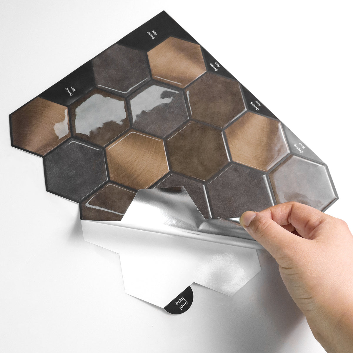 Hexagonal tile samples on a stand with a hand holding one tile