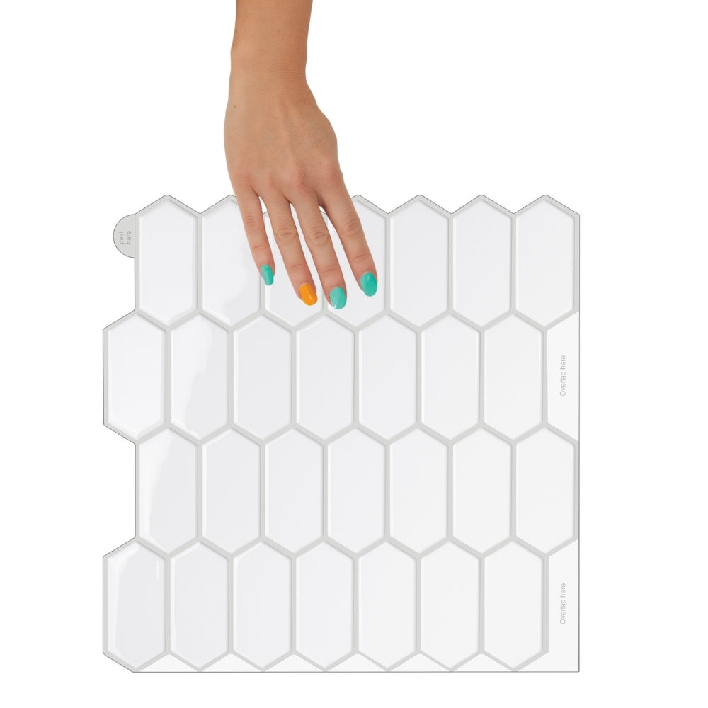 Bathroom with hexagonal white tiles, wooden vanity, and round mirror.