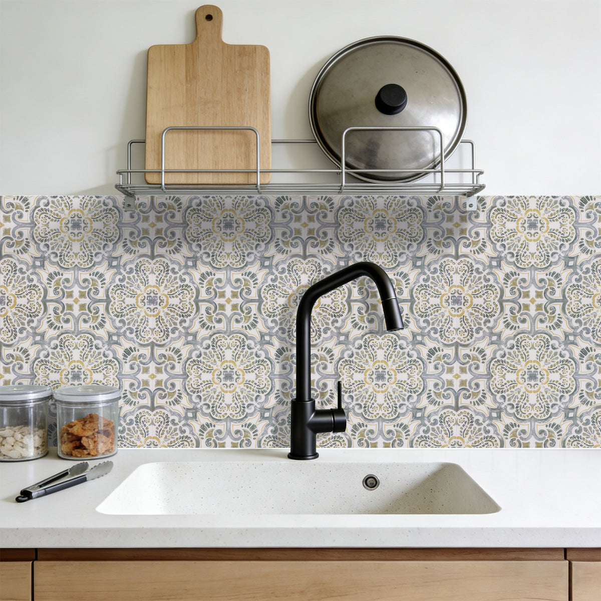 Kitchen with patterned tile backsplash, black faucet, and wooden cutting board.