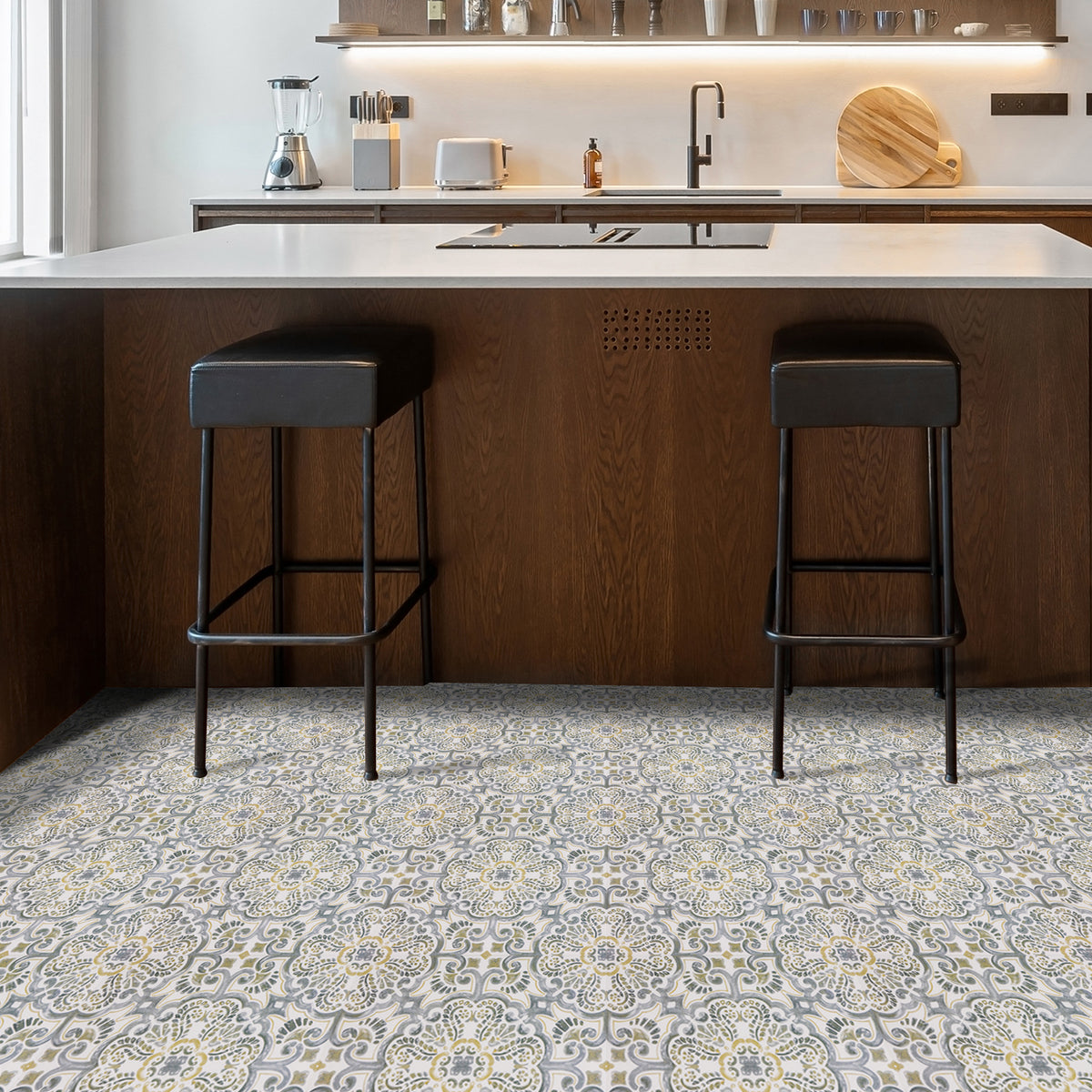 Kitchen with patterned floor tiles and bar stools.