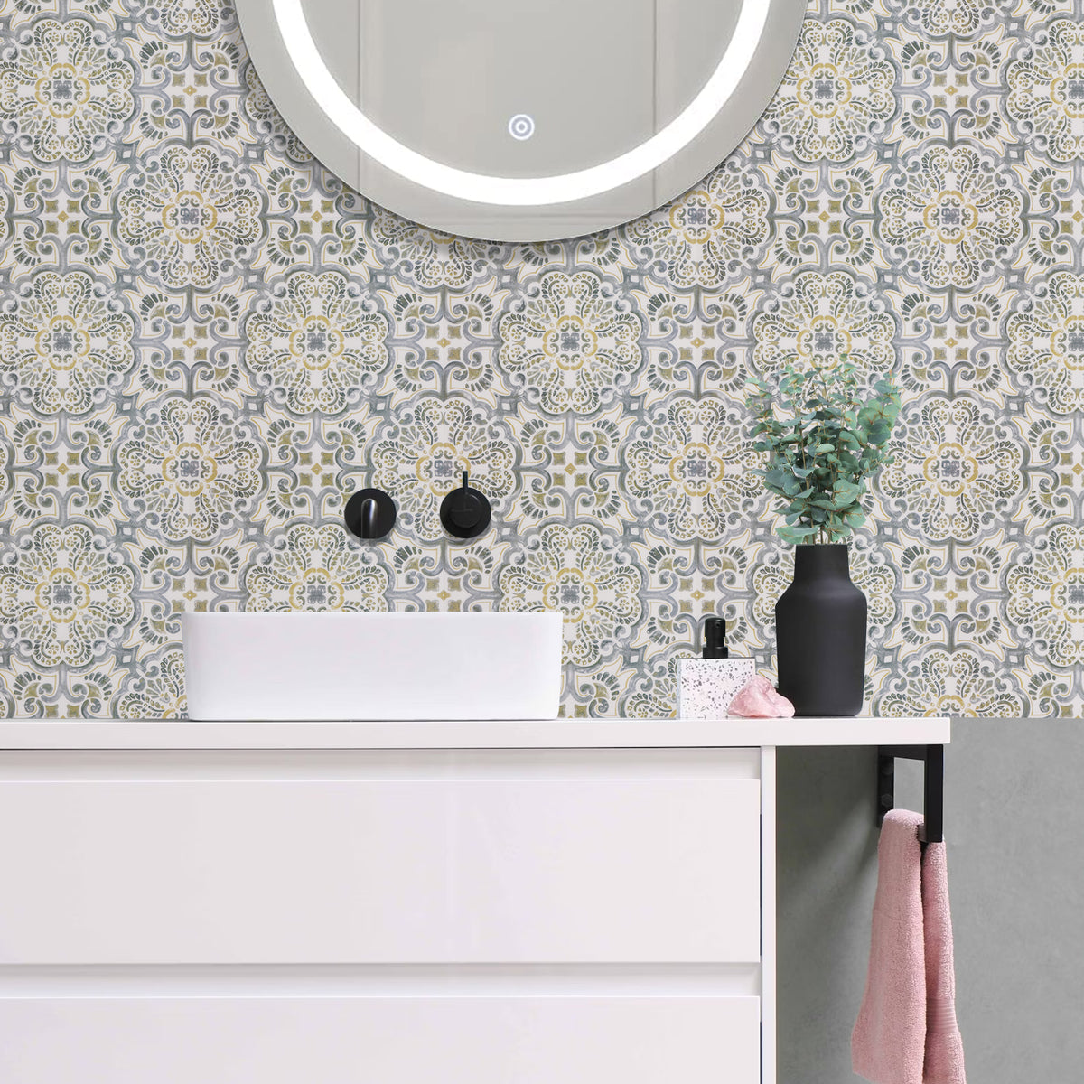Bathroom vanity with decorative tiles, mirror, and small plant.