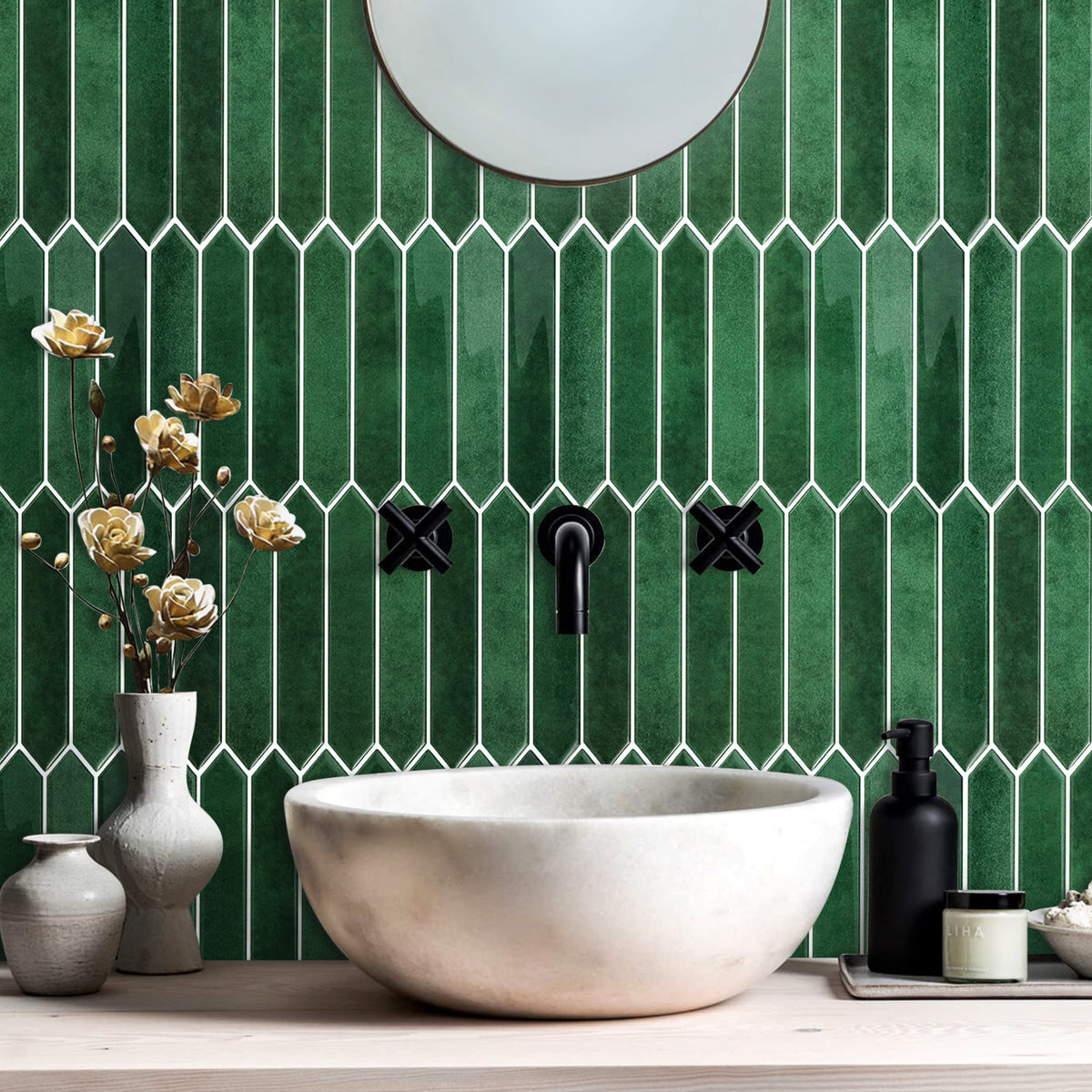 Bathroom with green picket tiled wall, white sink, and decorative elements.