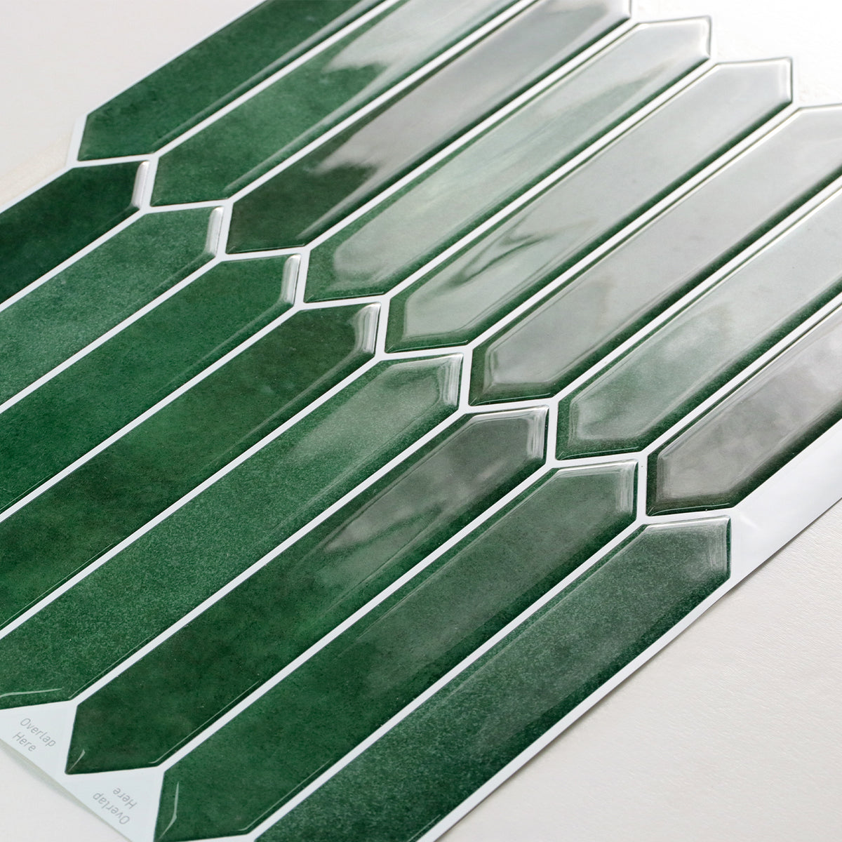 Green and white picket mosaic tiles on a white background