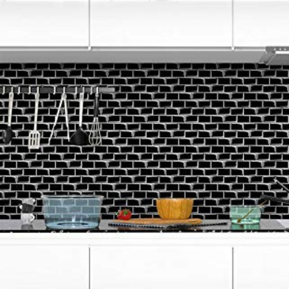 Black tiled backsplash with white text and kitchen utensils in a kitchen setting