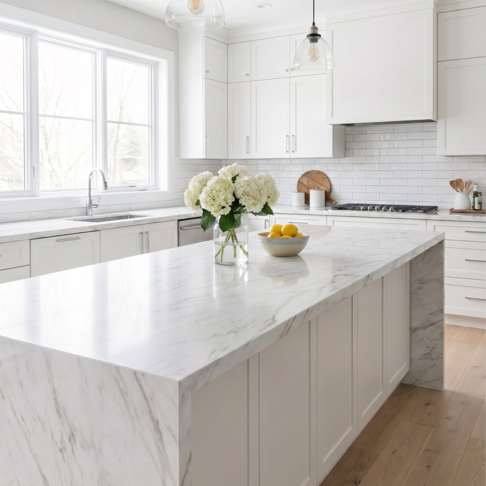 Modern kitchen with marble island and white cabinets