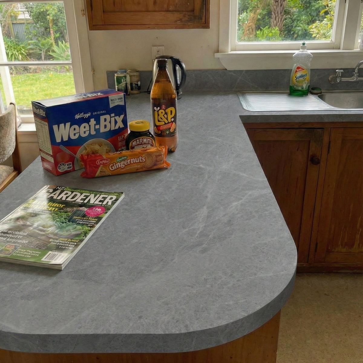 Kitchen counter vinyl wrapped with grey marble with Weet-Bix cereal box, Tropicana juice box, and a magazine.