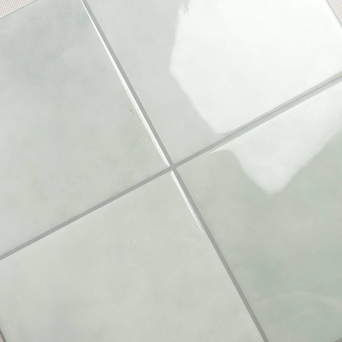 Close-up of light green tiles with a subtle pattern