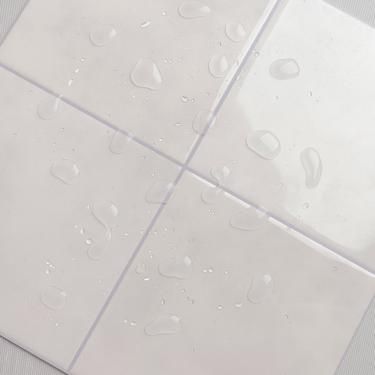 Sand coloured peel and stick tiles with waterdrops on a white background
