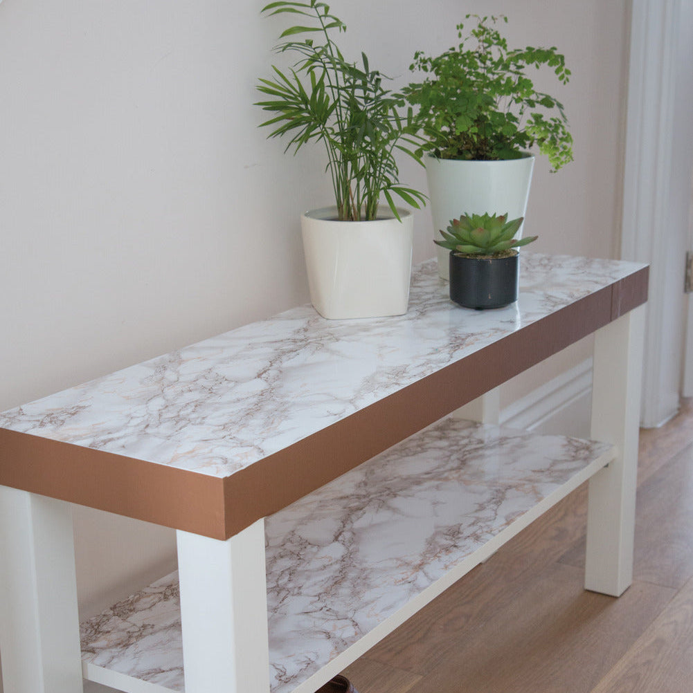 Marble-patterned table with potted plants in a room setting