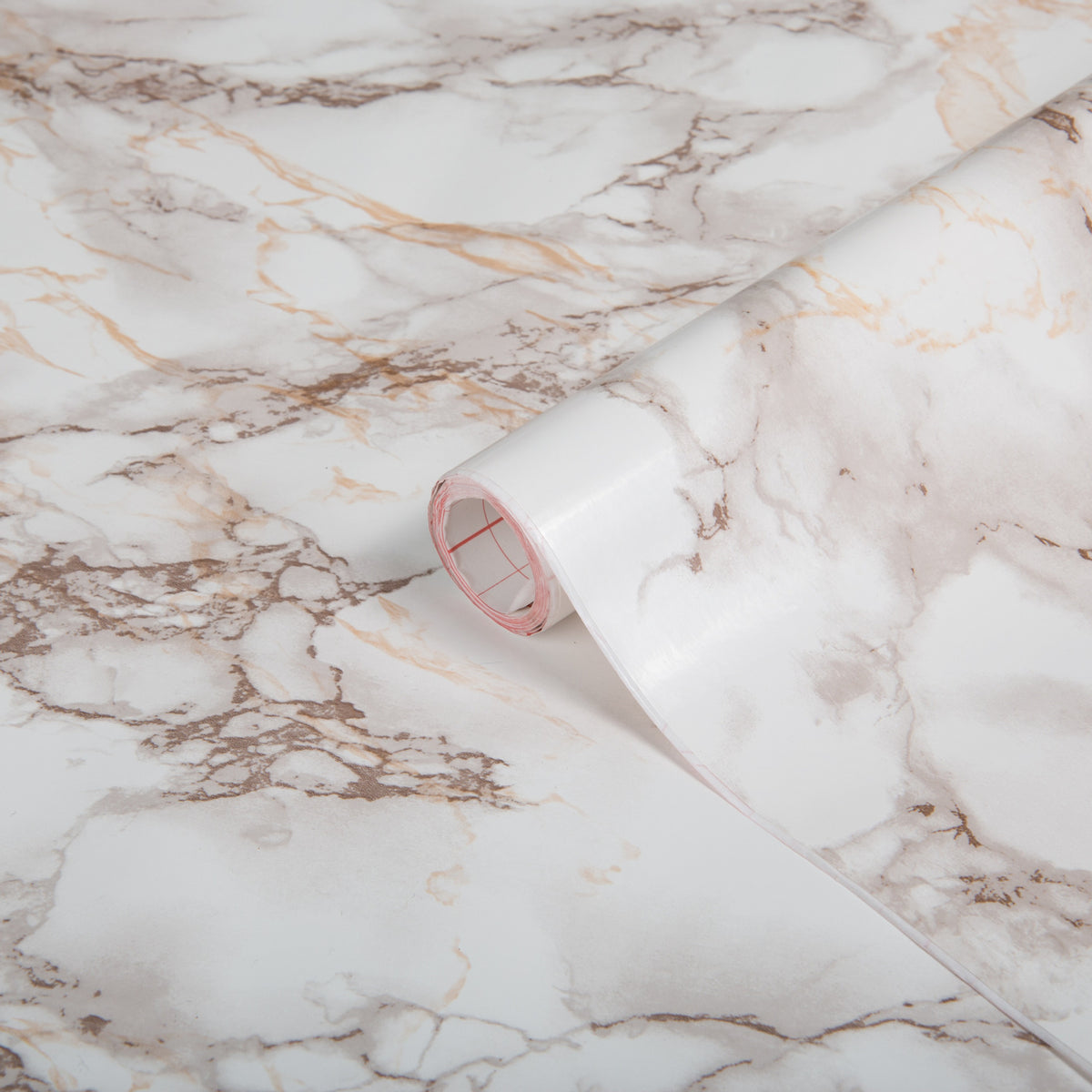Roll of marble-patterned paper on a marble surface