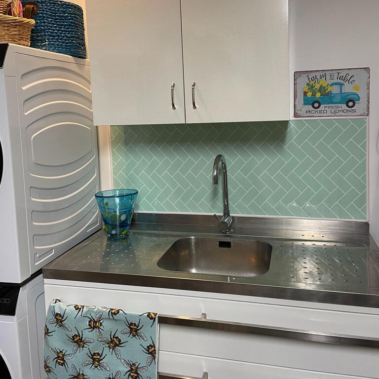 mint herringbone tiles in laundry room