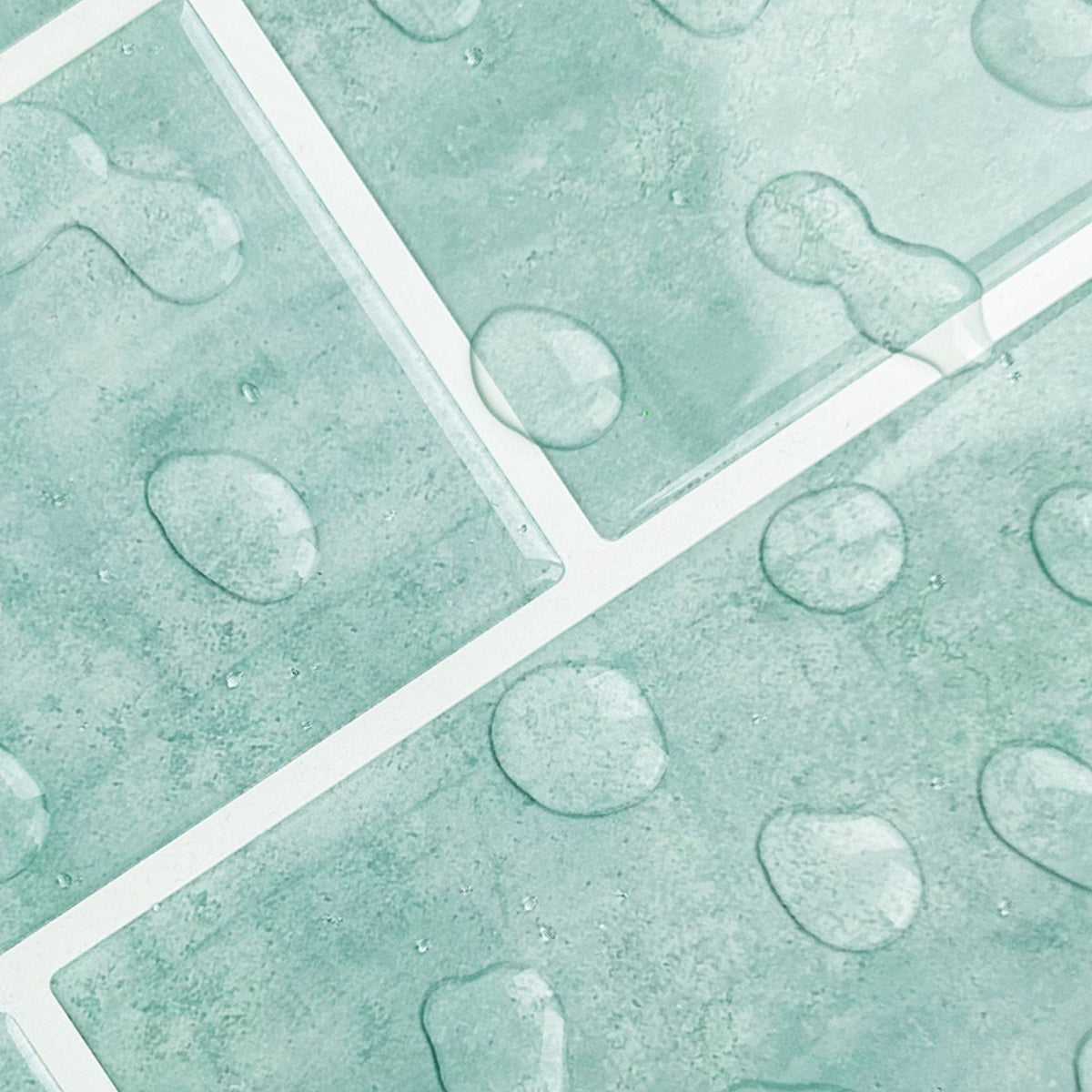 Mint green textured tiles with a raised water drops and white grout lines.