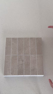 Stacked subway textured beige composite tiles being shown