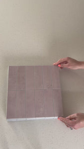 Stacked subway pink gloss composite tiles being shown