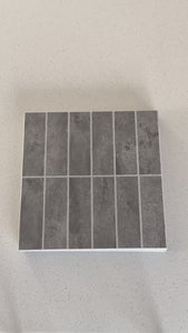 Stacked subway slate grey composite tiles being shown