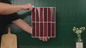 Installation of burgundy kit kat peel and stick tiles