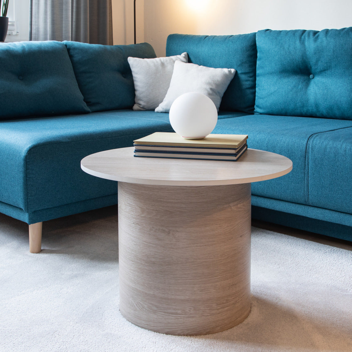 round coffee table covered with santana oak lime adhesive vinyl and a blue couch