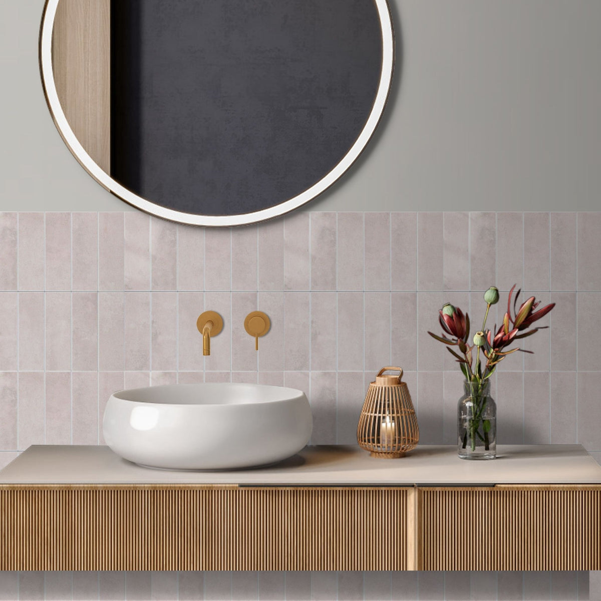 Bathroom vanity with a mirror above and pink stacked subway tiles splashback